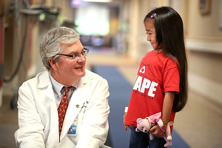 physician with female patient in hallway