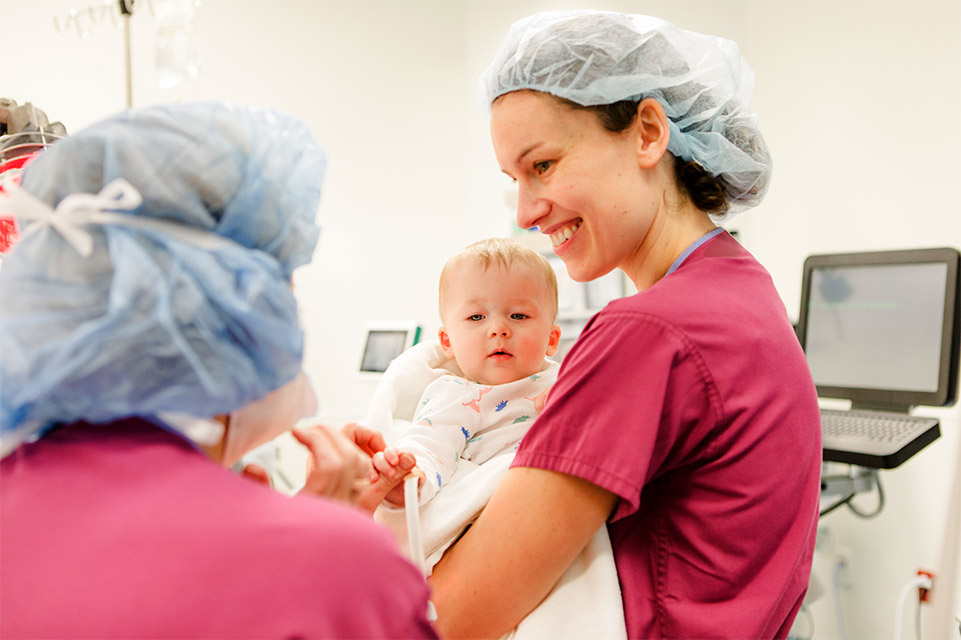 Nurse holding infant patient