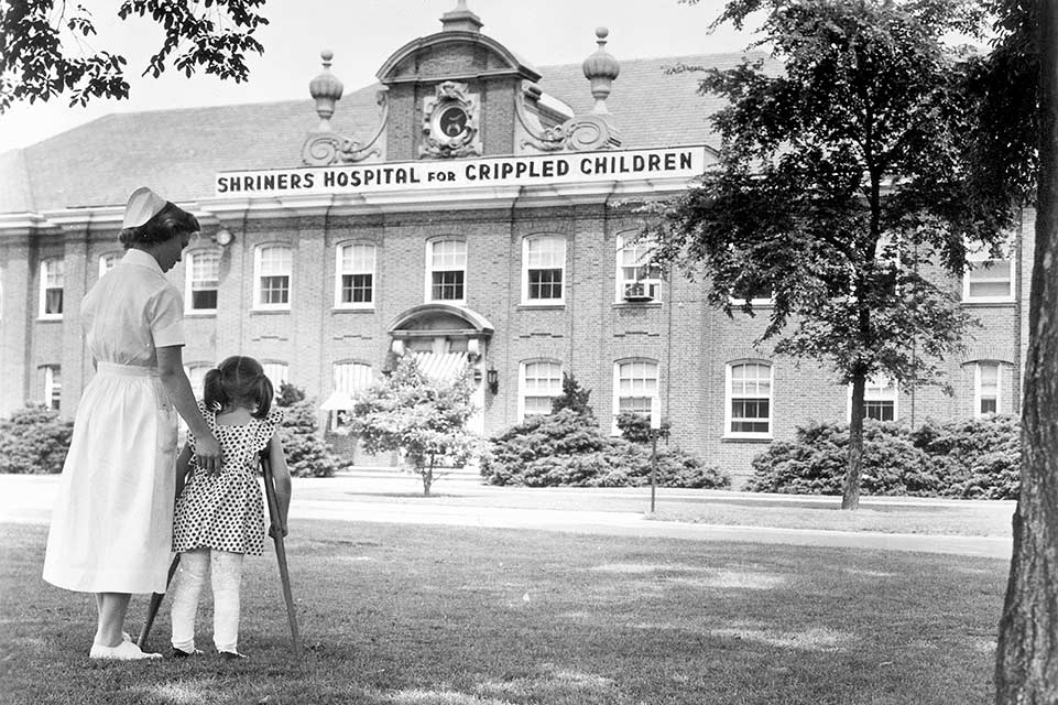 Nurse and patient in front on Chicago hospital during 1920s