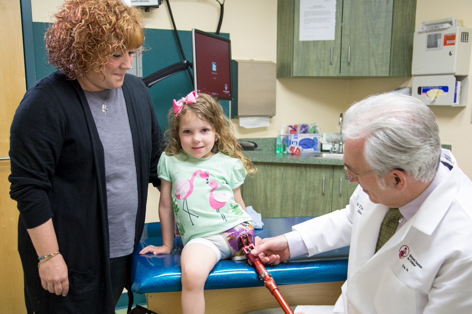 Patient with prosthesis, mom and physician