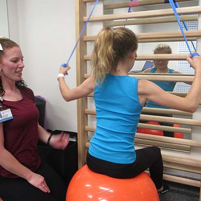 patient and physical therapist during PT session