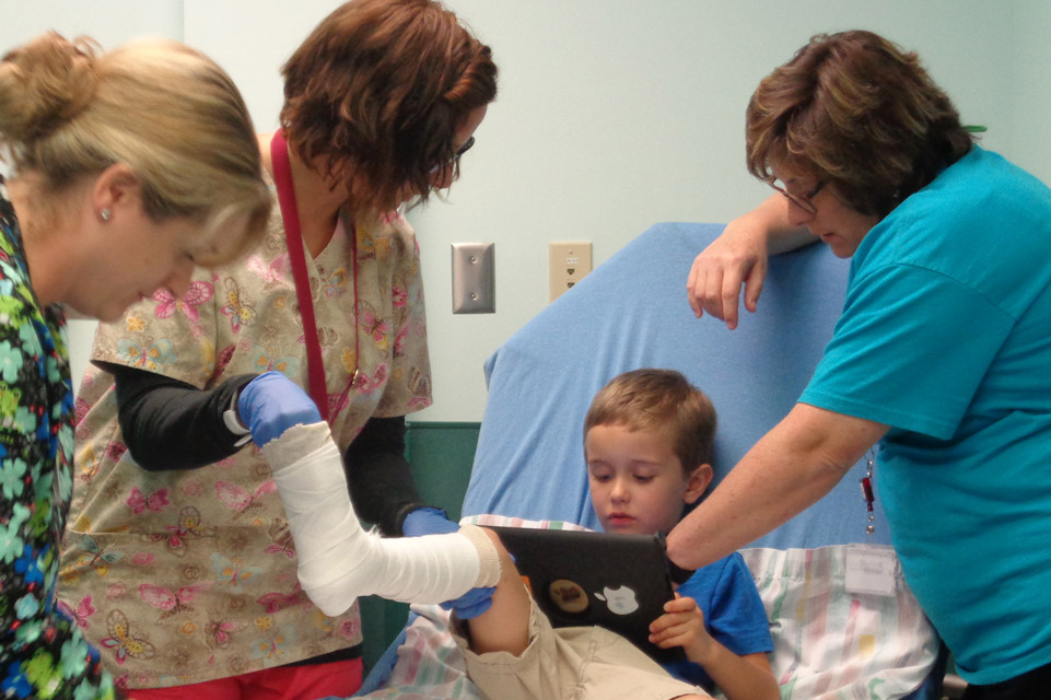 three staff members and patient during leg casting