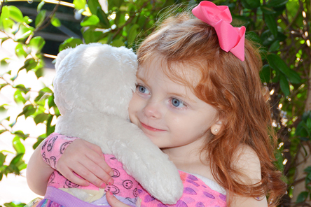 female patient hugging doll