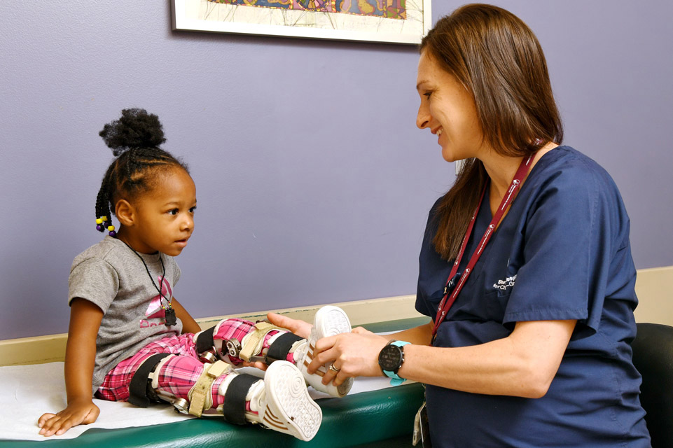 staff member examines patient on table