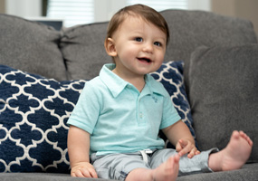 toddler boy sitting on couch