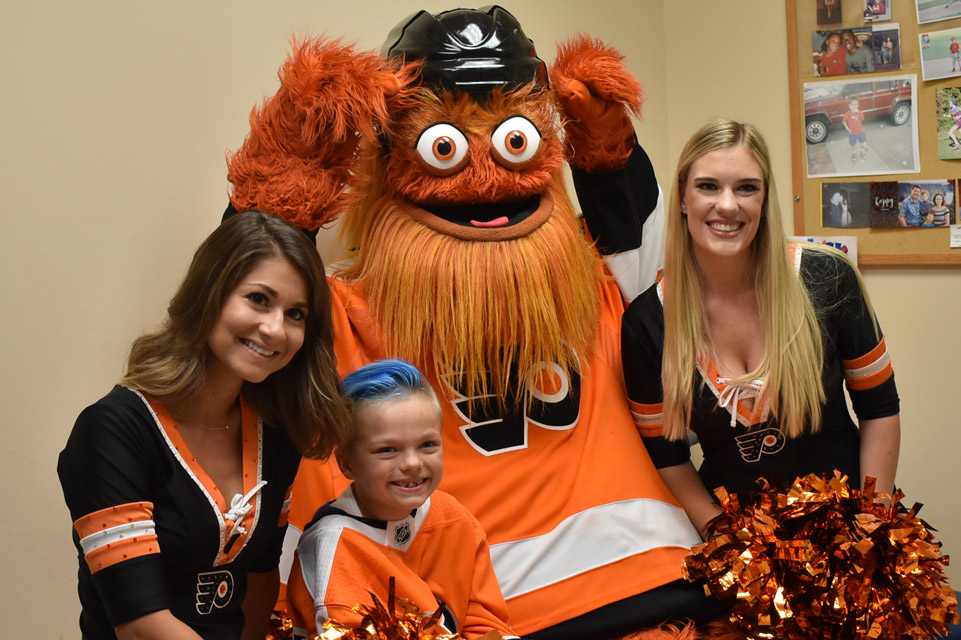 la mascotte du hockey de Philadelphie, les meneuses de claque et le patient