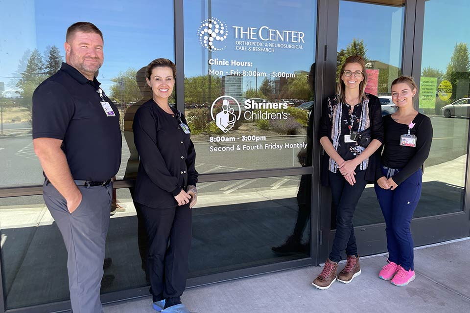 four staff members outside Redmond clinic building