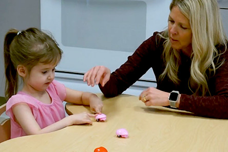 female patient and therapist sitting at table