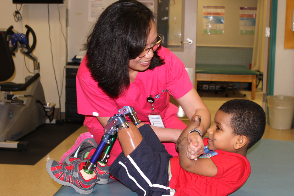 staff member working with patient with prosthetic legs