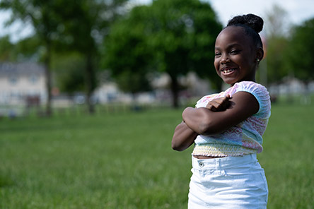 patient outside, arms crossed and smiling