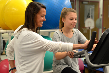 staff member and patient during physical therapy session