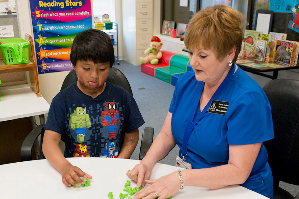 patient and staff member playing at a table