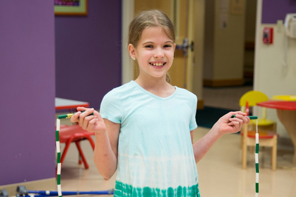 female patient holding jump rope