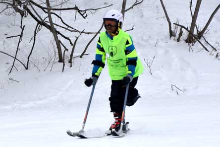 patient snow skiing with adaptive equipment