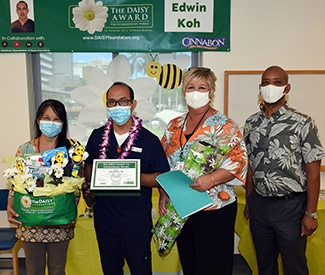 Edwin Koh with his award, other staff members