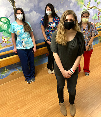 Lorryn standing in hospital with other staff members