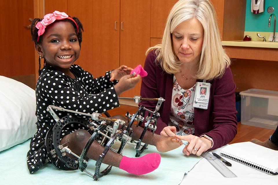 Marie Eva with staff member