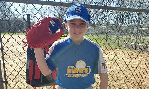 Charlie on baseball field with glove