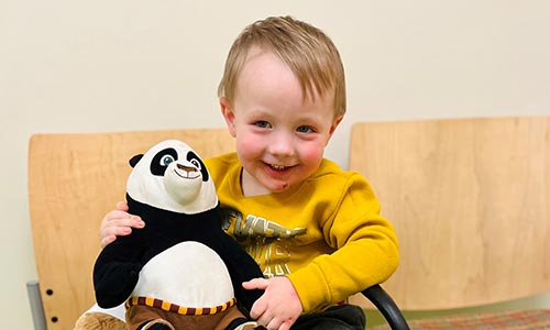 Grayson holding stuffed animal