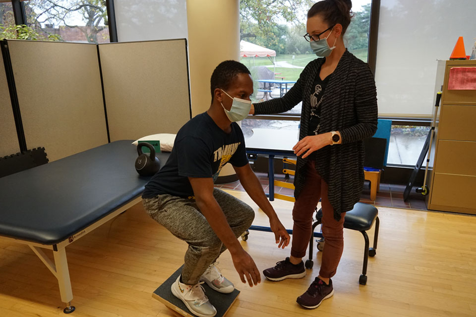 Therapist and spinal cord injury patient during physical therapy 