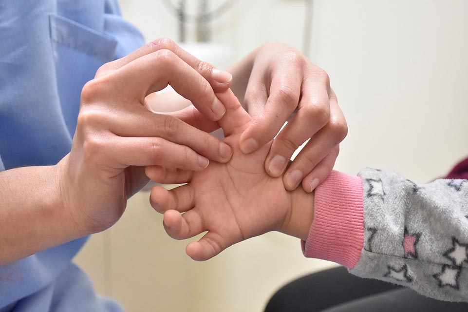 Staff treating a patient's hand