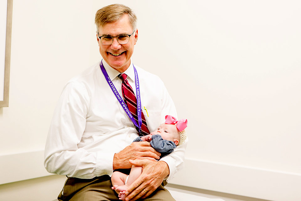 male provider holding infant patient