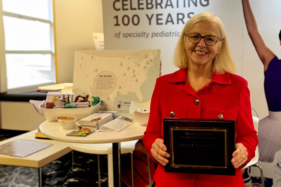 surgeon Colleen Ryan, M.D., holding an award