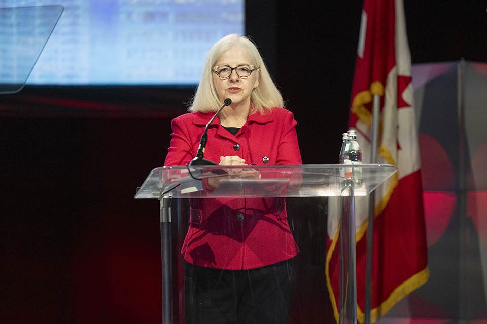 Colleen Ryan speaking at podium