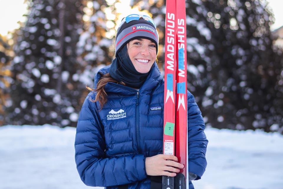 paralympian Dani holding skis outside