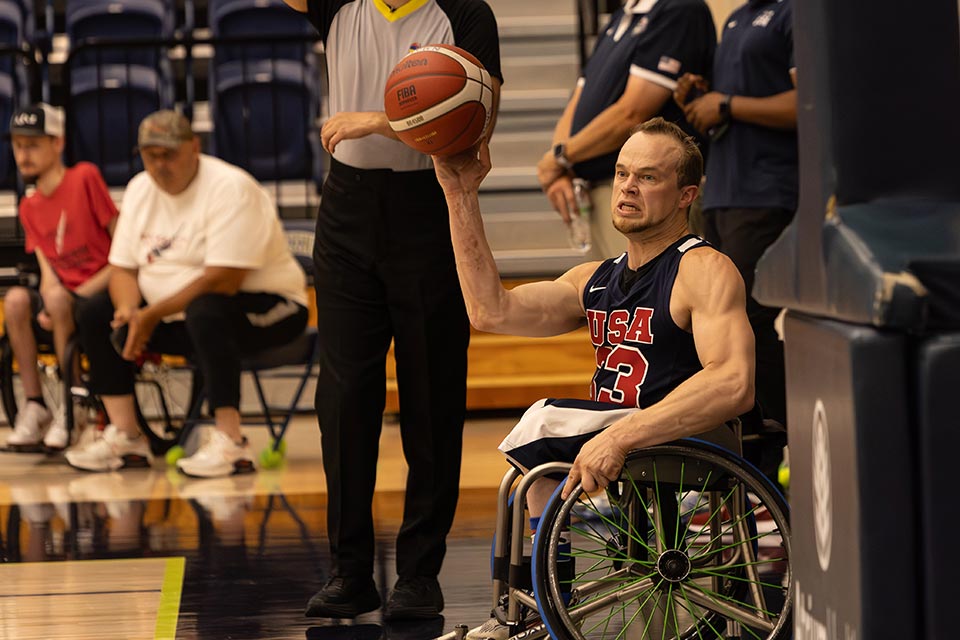 John competing in wheelchair basketball game