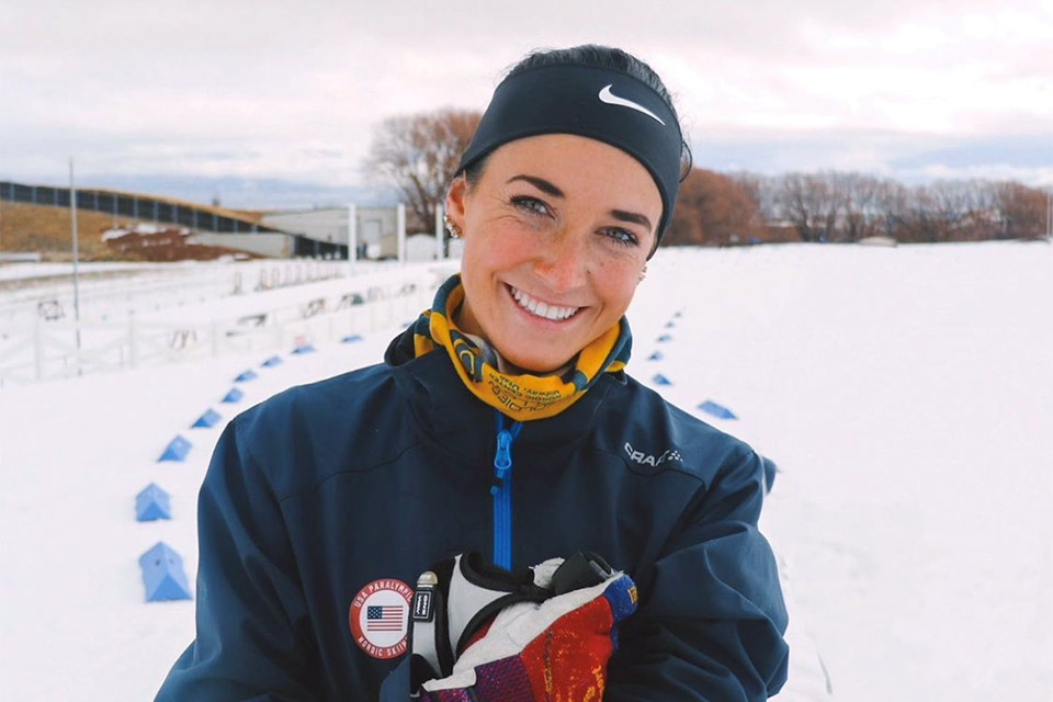 La atleta paralímpica y paciente, Dani, parada afuera en la nieve