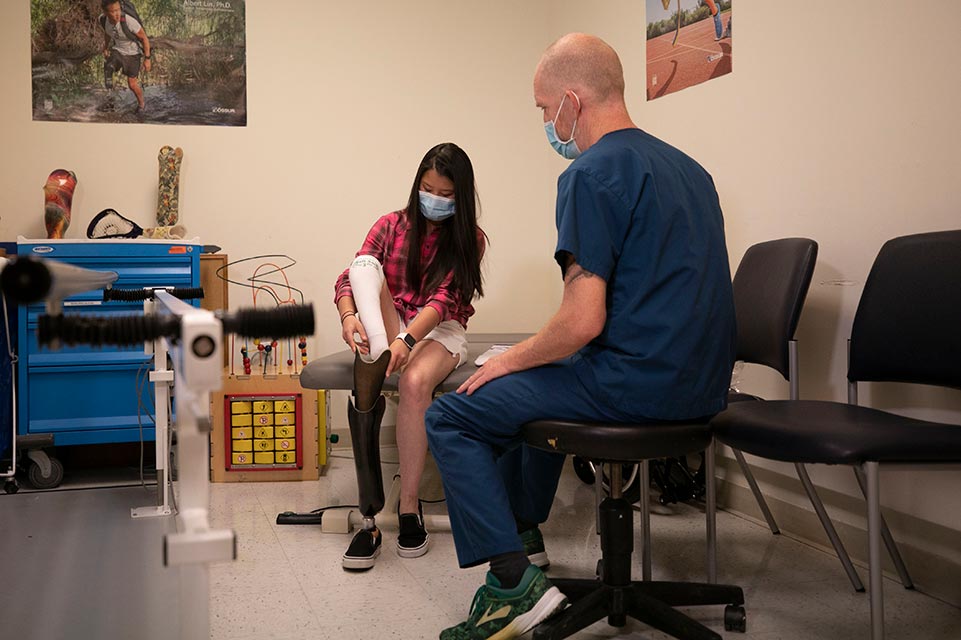 Andie Sue with prosthetist in POPS department