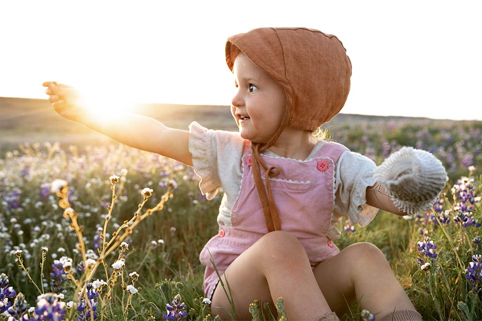 Lina sitting in a field