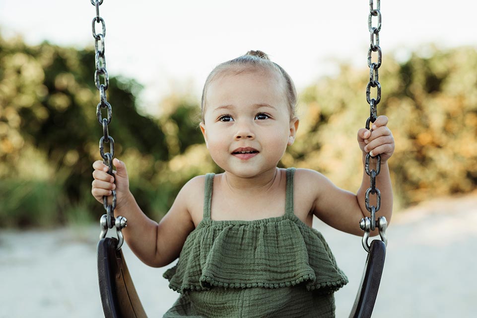 Mia on swing on playground