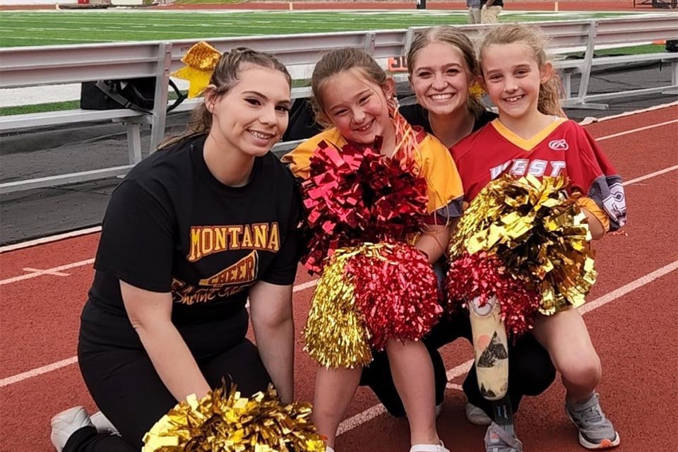 Cheerleaders on the track with pom poms