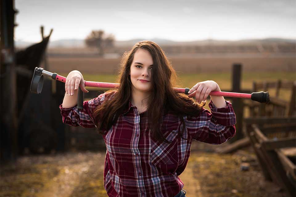 Maggie outdoors holding her brace behind her head