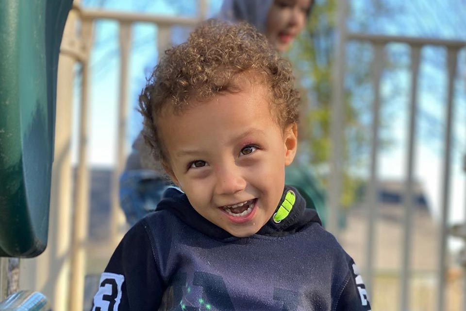 D'artanian smiling while playing on playground