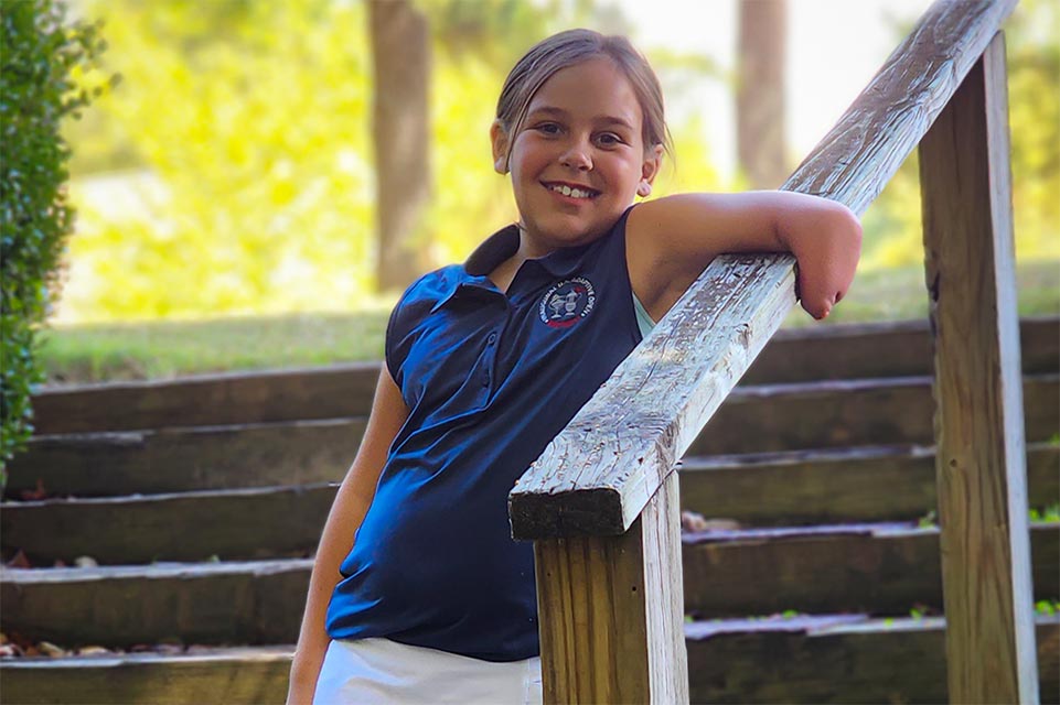 zoe standing on steps smiling