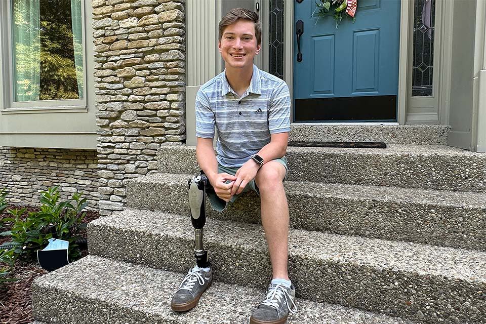 Grayson sitting on home front steps