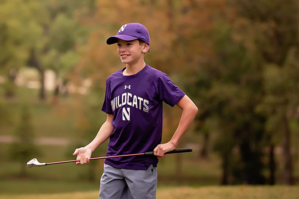 patient in sports uniform holding golf club