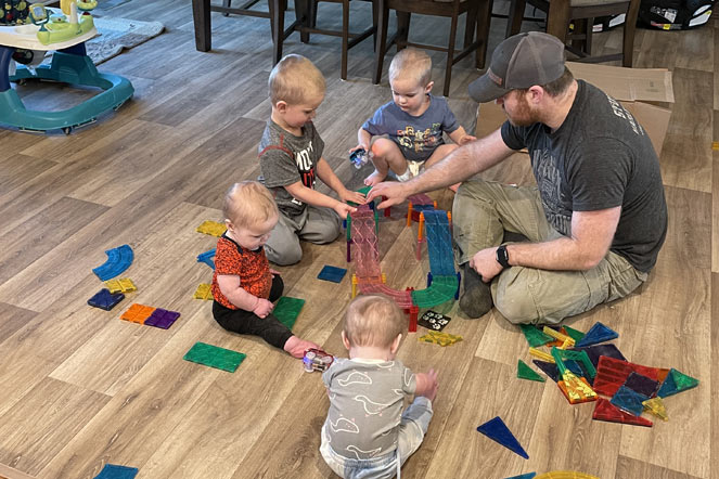 Nolan playing with siblings and father