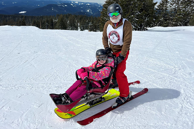 Patient skiing with recreational therapist