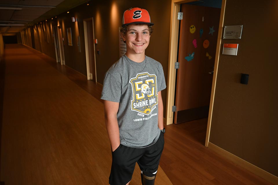 Colton smiling, wearing 50th Shrine Bowl T-shirt