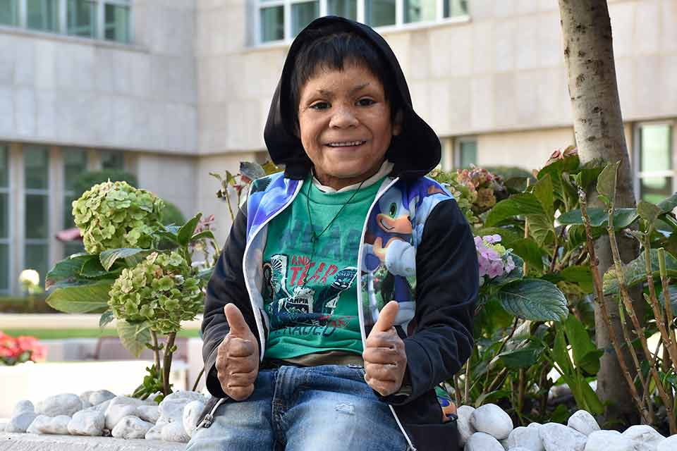 Young male patient sitting and giving two thumbs up