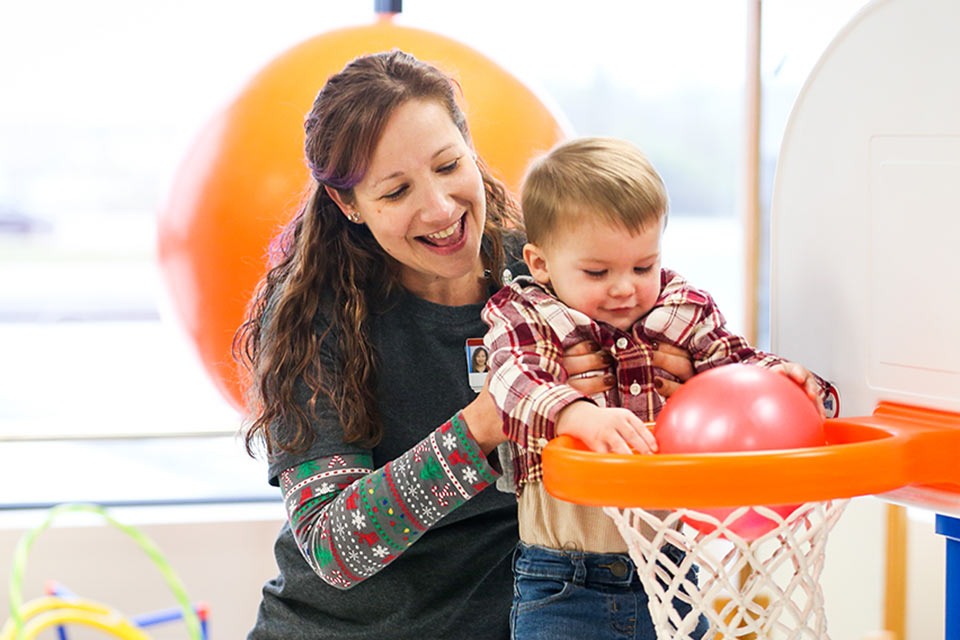 Therapist playing basketball with patient