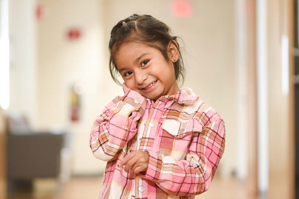 Female patient smiling with hand on cheek