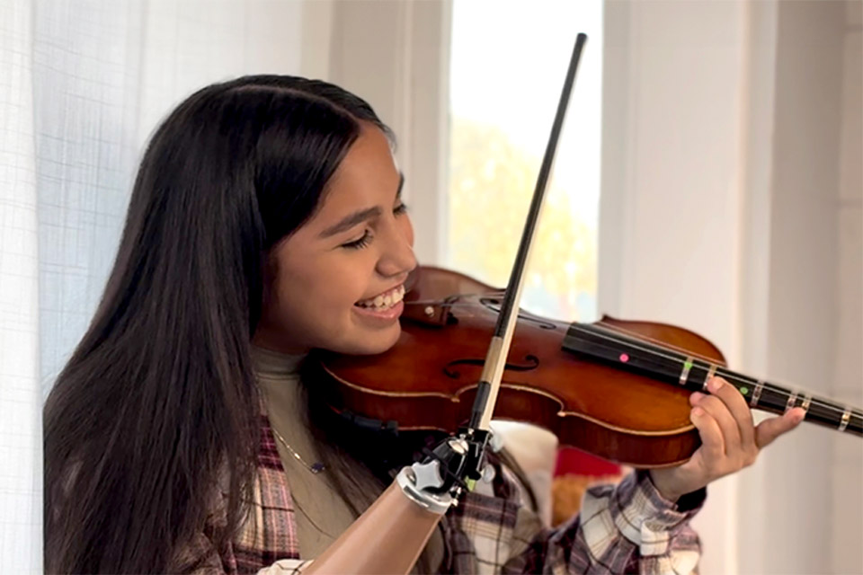 Patient playing violin with prosthetic arm