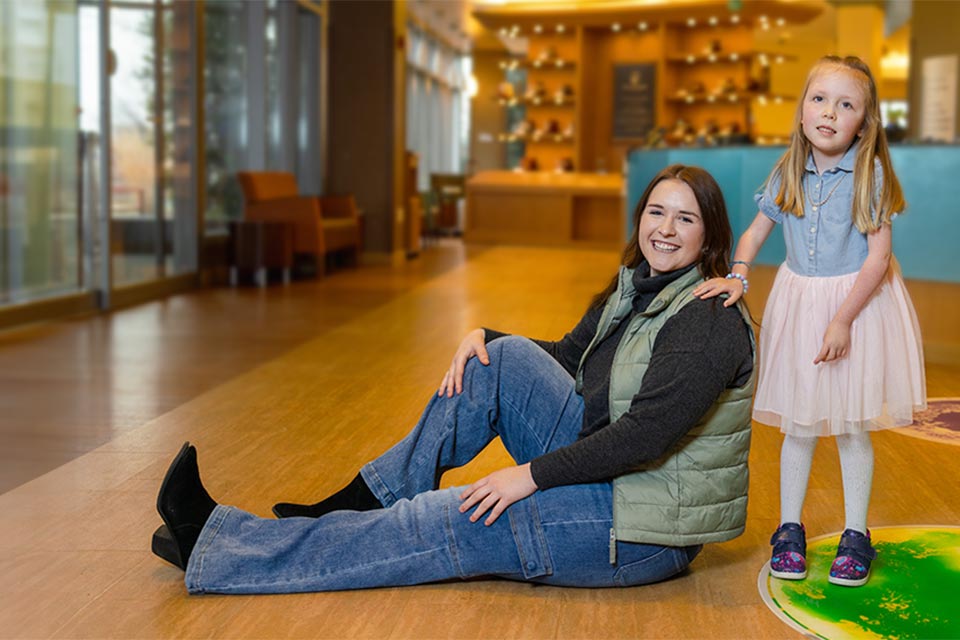 Two female patient smiling in hospital lobby