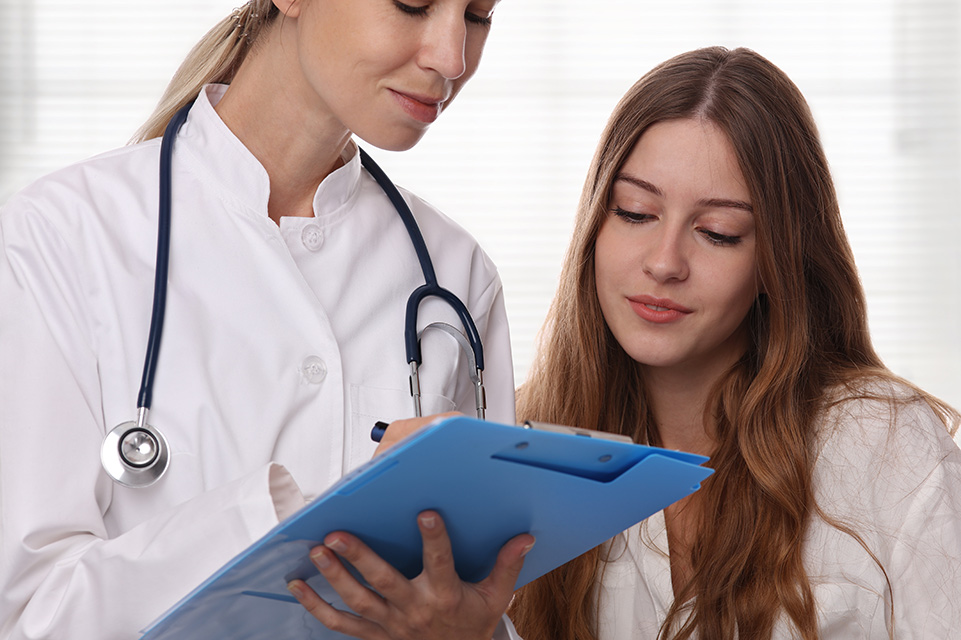 adolescent female patient and physician