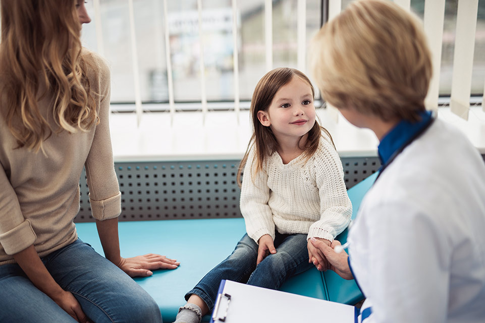 female patient and mom speaking with physician